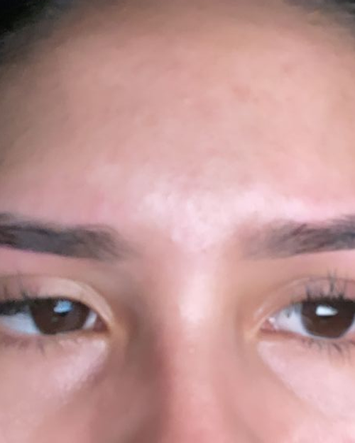 Client photo showing precisely shaped eyebrows, close up
